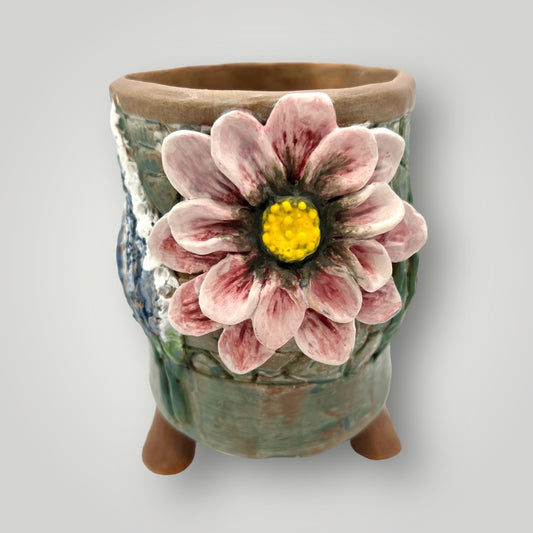 Expertly handcrafted, this DS81 3D ceramic pot features a charming pink flower motif and a round, long design. Perfect for displaying your favorite plants, this pot adds a touch of handmade elegance to any space.