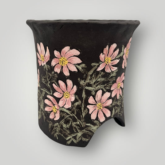 Experience the beauty of nature with DS 10. Adorned with hand painted cosmos flower details, this tall round pot adds a touch of elegance to any space.&nbsp; Transform your space / garden into a tranquil environment with this 6W X 6.25H planter.